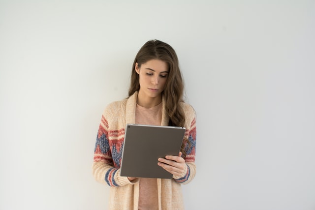 Woman reading online about how to properly pack electrical equipment