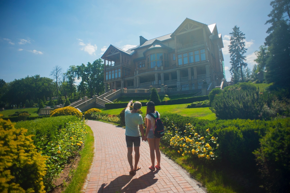 A couple looking at their new home and holding hands.