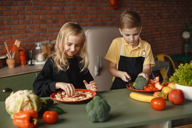 A boy and a girl preparing food in the kitchen