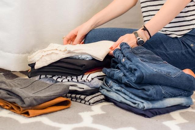 A woman decluttering her clothes.