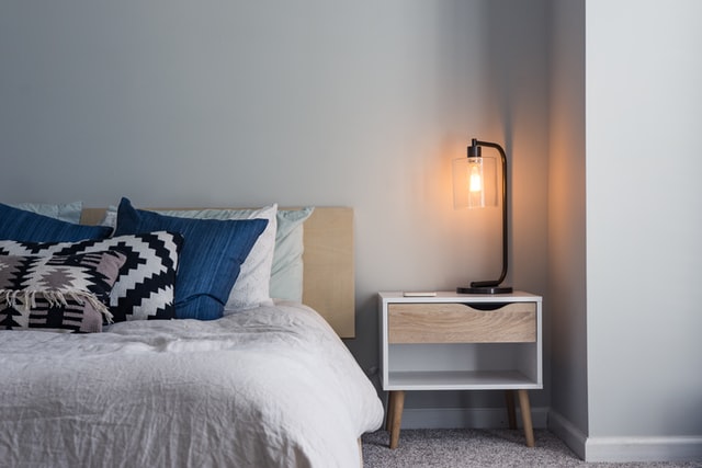 a bedroom with light gray walls