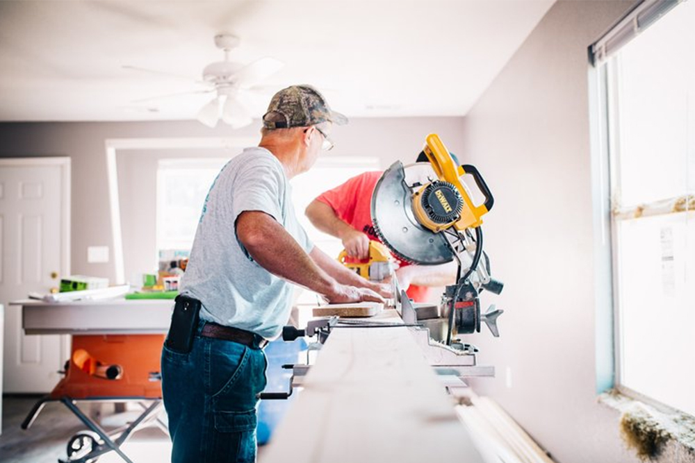 Contractors working while residents decided to move out during a home remodeling project