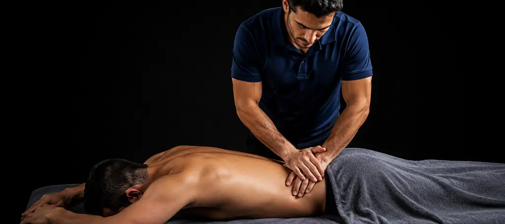 Licensed Elite Healers therapist performing a clinical lower-back and
lumbar release for a client at Elite Healers Sports Massage, a clinical sports massage practice for athletes and active professionals rated 4.9 stars across over 200 reviews in NYC.