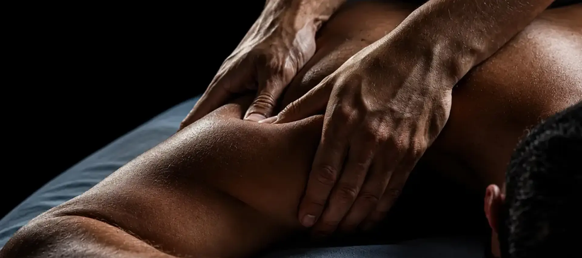 Licensed Elite Healers Sports Massage therapist performing a deep-tissue shoulder and mid-back release for a client at Elite Healers Sports Massage, the Midtown Manhattan performance recovery practice, located at 120 East 56th Street, Suite 420, New York, NY 10022.