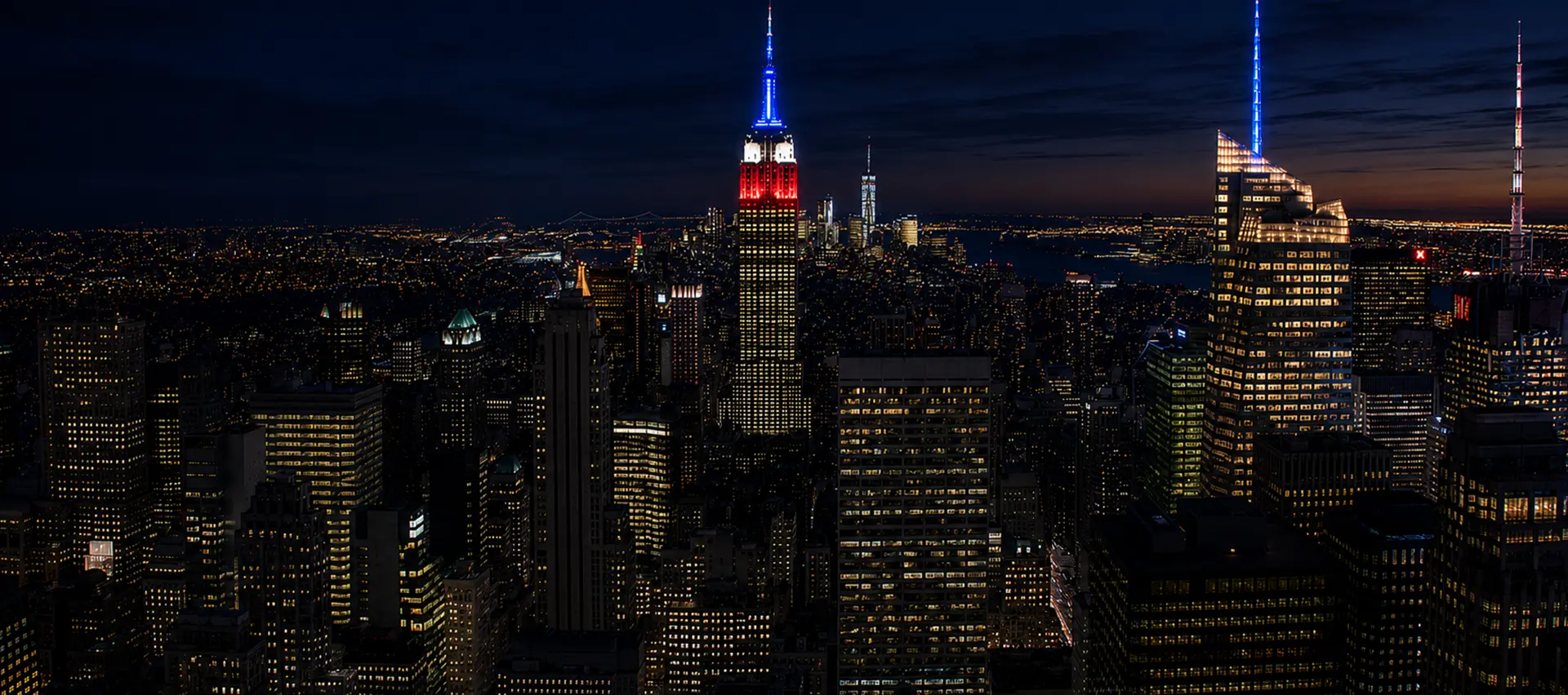 Manhattan skyline at night featuring the Empire State Building, representing the New York City service area covered by Elite Healers Sports Massage, a clinical sports massage and performance recovery
practice located at 120 East 56th Street, Suite 420, New York, NY 10022.