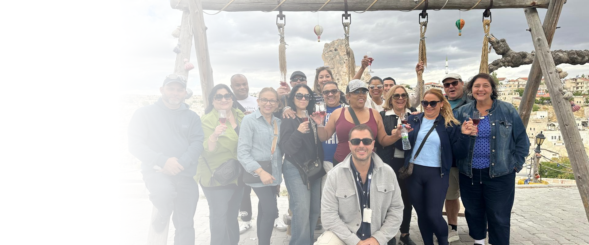 A smiling group of travelers enjoying a sunset city tour planned by a travel agency in Lodi.