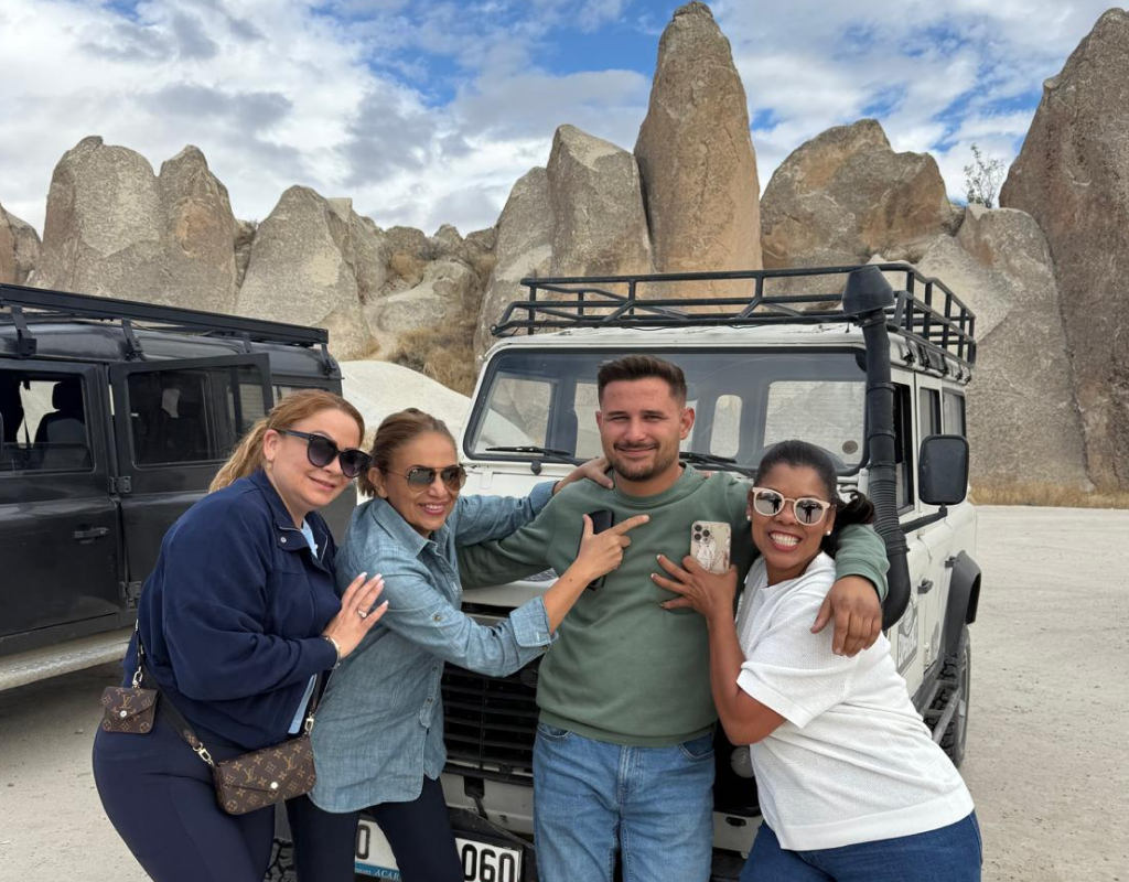A smiling group of travelers enjoying a sunset city tour planned by a travel agency in Lodi.