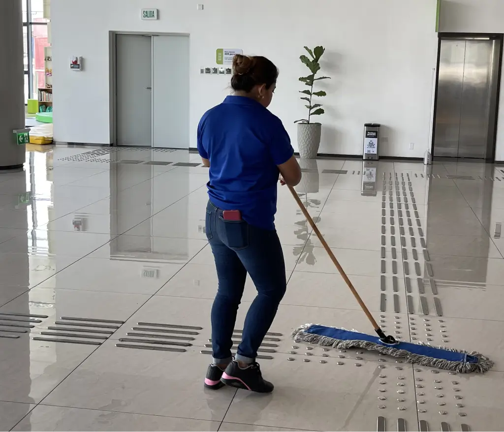 Team providing janitorial services in Atlanta inside a modern office lobby